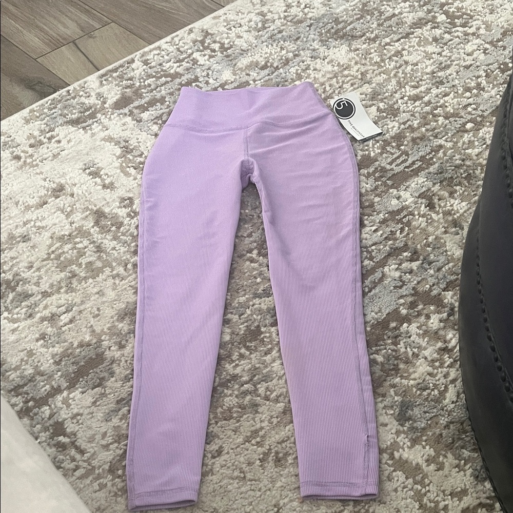 Super cute lilac leggings size Petite adult.  Small hole in the seam.